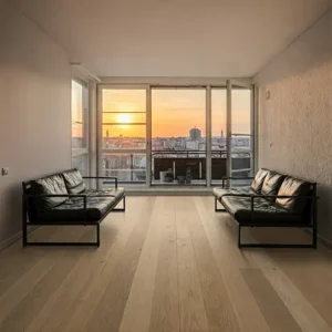 living room with lightcolored wood parquet flooring, a minimalist sofa, and a large window-interior splusa.id